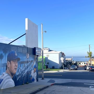 a wall drawn a man playing baseball