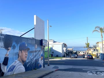 a wall drawn a man playing baseball