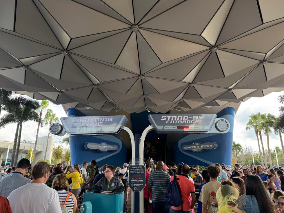 entrance to an amusement park ride with two lines for lightning lane and standby