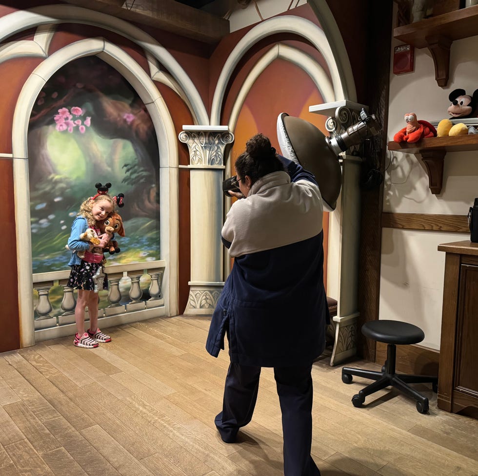 disney photo pass studio at magic kingdom a person holding a camera