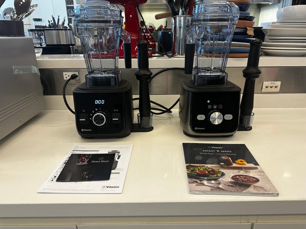 two vitamix blenders on the countertop in the lab, empty with their interface lit up