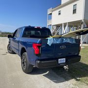 ford lightning with surfboards in the bed
