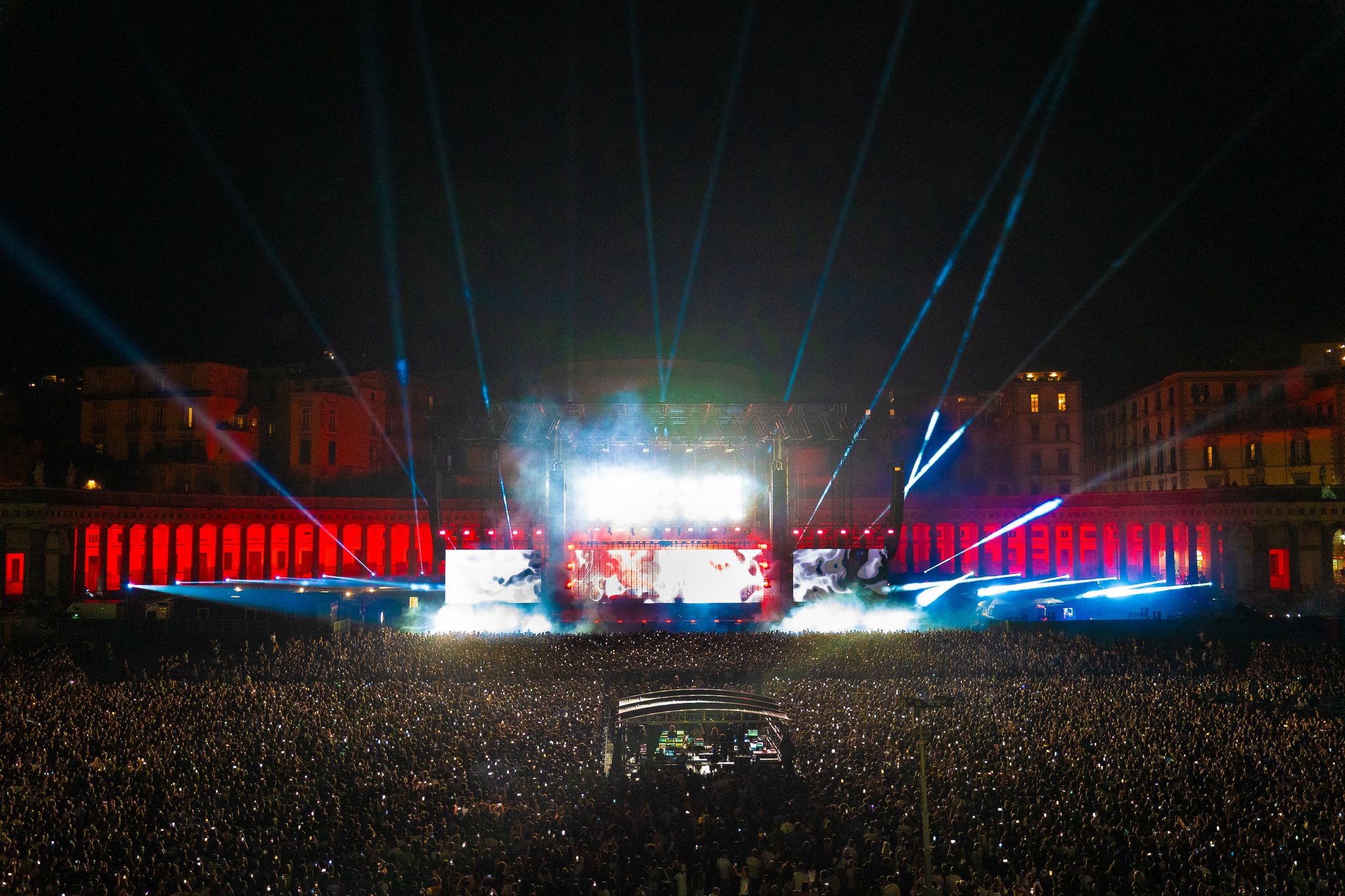 a stage with lights and a crowd of people