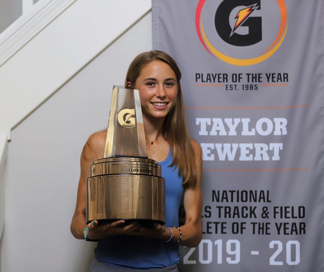 taylor ewert holds her gatorade player of the year award after being surprised at home with the trophy