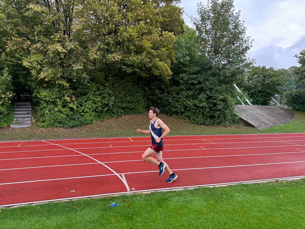 aaron gruen runs on a track