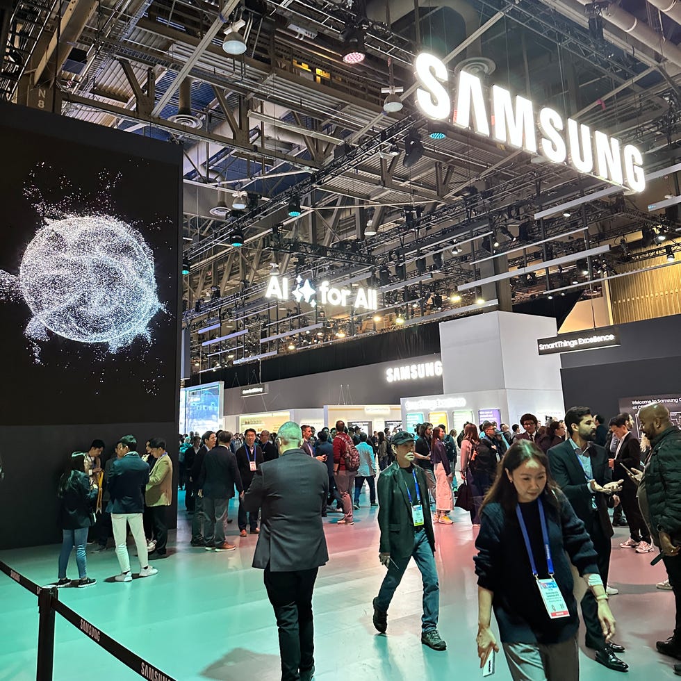 samsung exhibition booth at a technology event with a crowd and interactive display