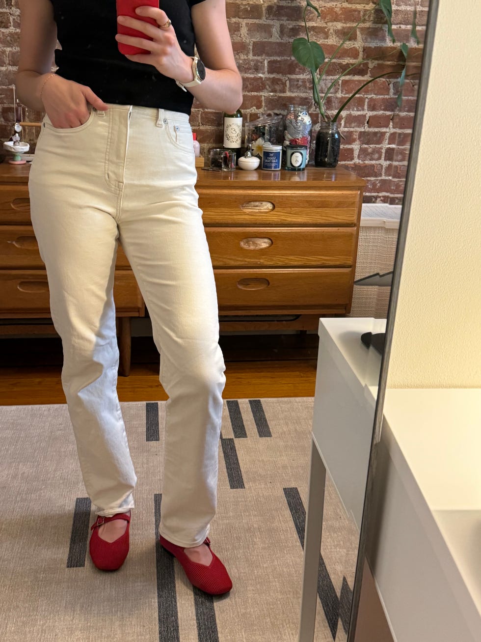 a tester wearing white madewell jeans, testing for good housekeeping's best jeans for women