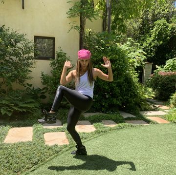 halle berry doing an exercise move in her backyard