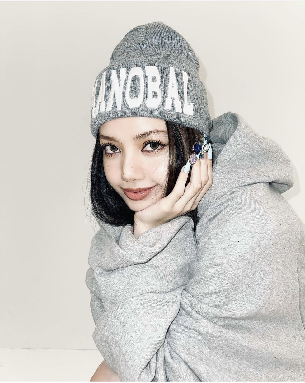 a person wearing a grey hoodie and a grey beanie