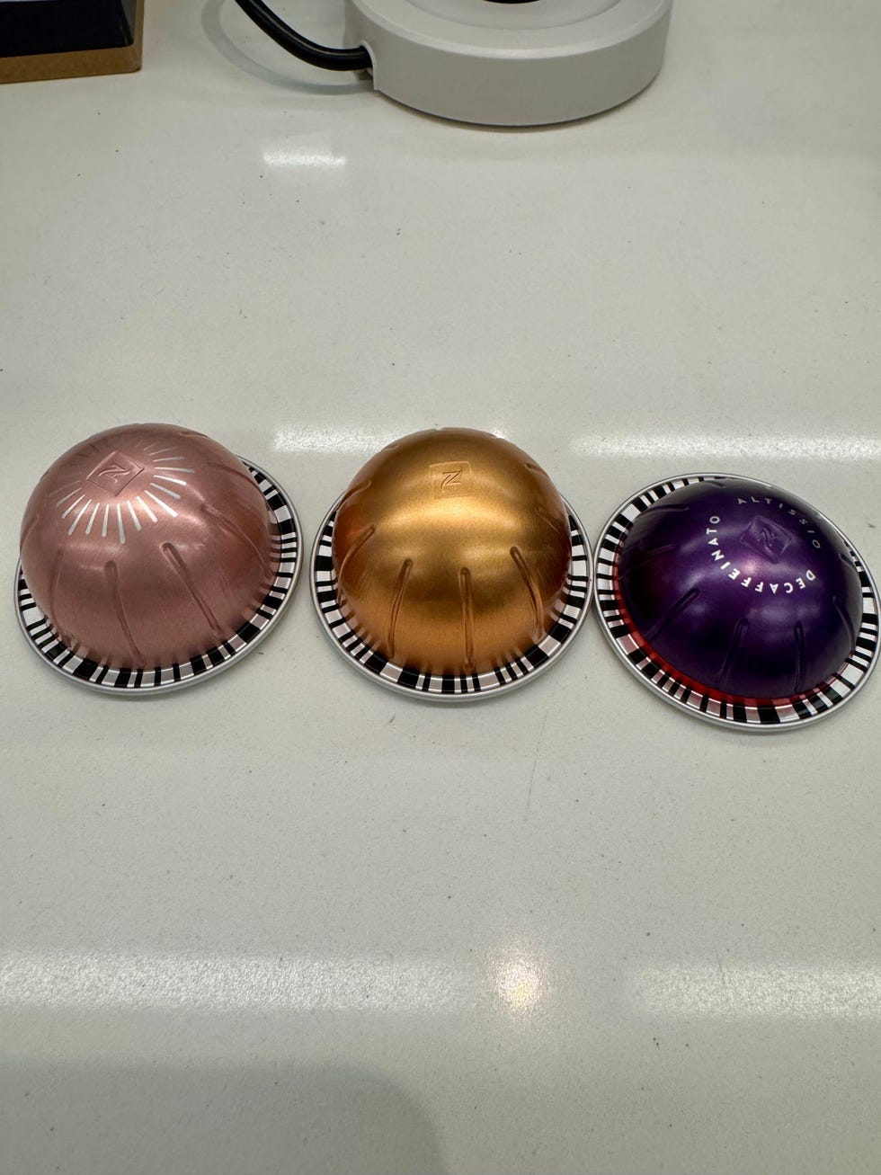 three nespresso vertuo capsules on a counter