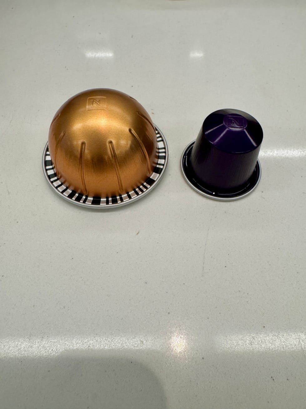 nespresso original and vertuo capsules on a counter