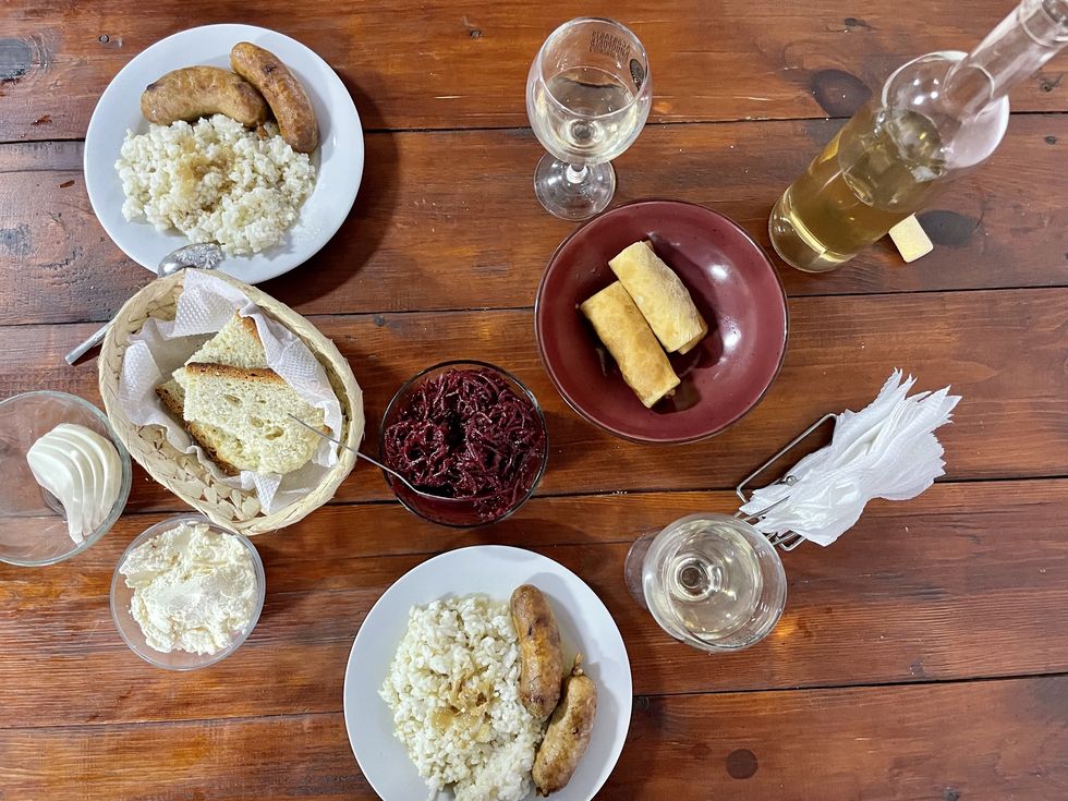 a table with plates of food and glasses of water