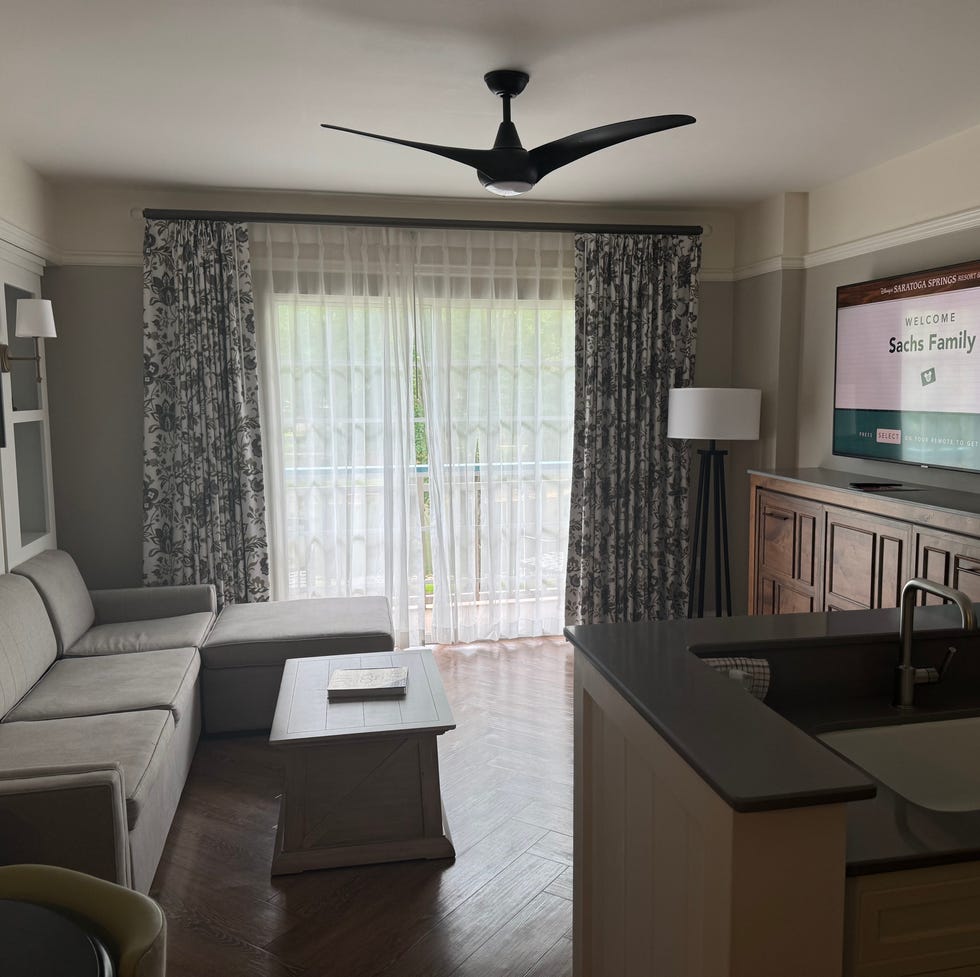disney world saratoga springs villa a living room with a tv and a couch