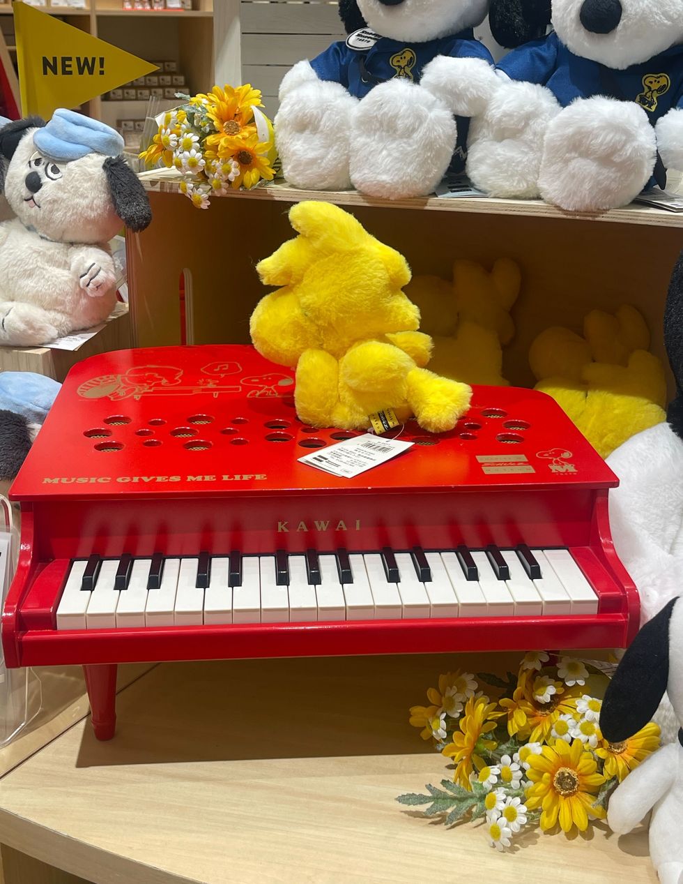 a group of stuffed animals sit on top of a piano