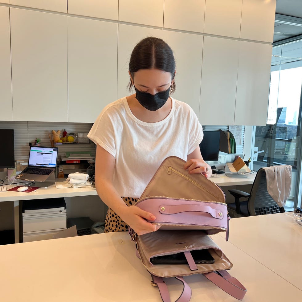 Best College Backpacks - Lab analyst evaluating backpack features lab analyst in a white shirt is analyzing features of a purple backpack in lab to find the best college backpacks