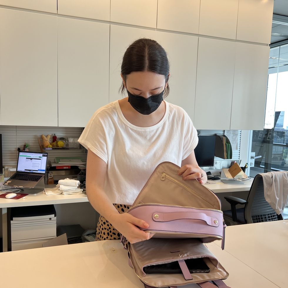 a good housekeeping lab analyst testing a backpack in the good housekeeping institute to find the best laptop bag for women