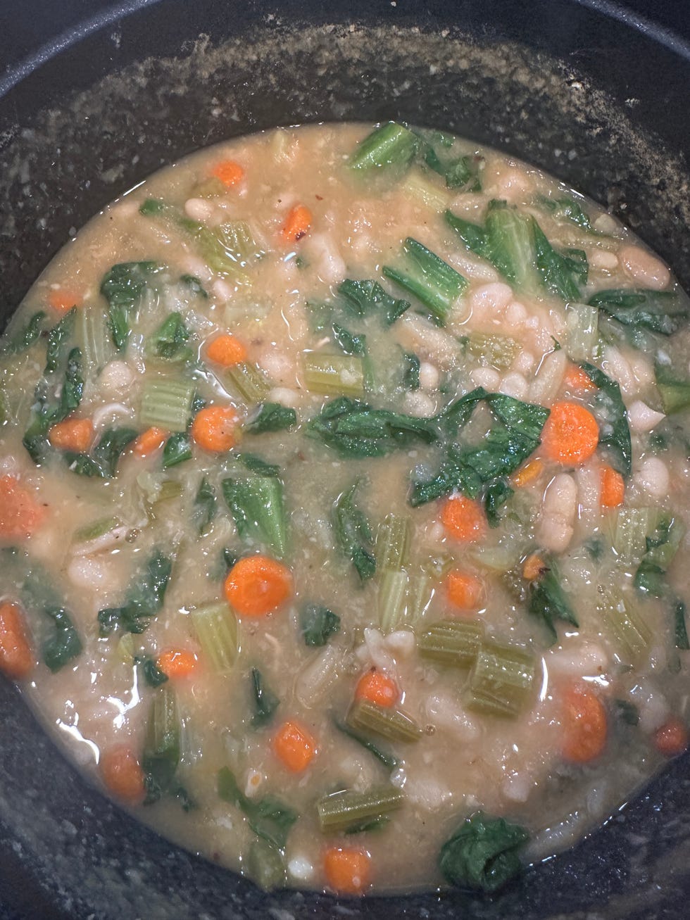 white bean and escarole soup inside of staub dutch oven