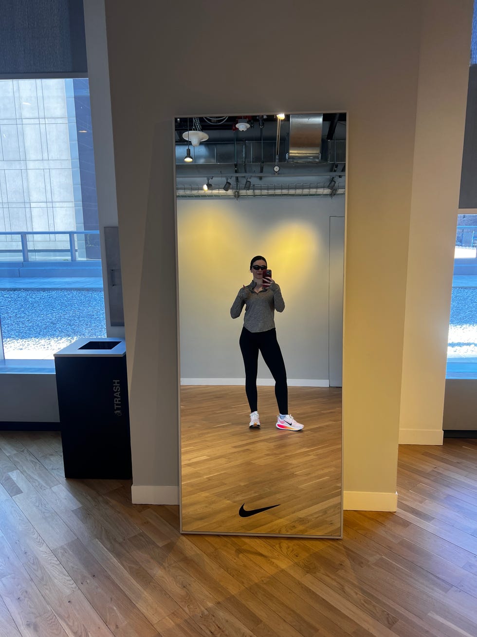 fulllength mirror reflecting an individual in athletic wear