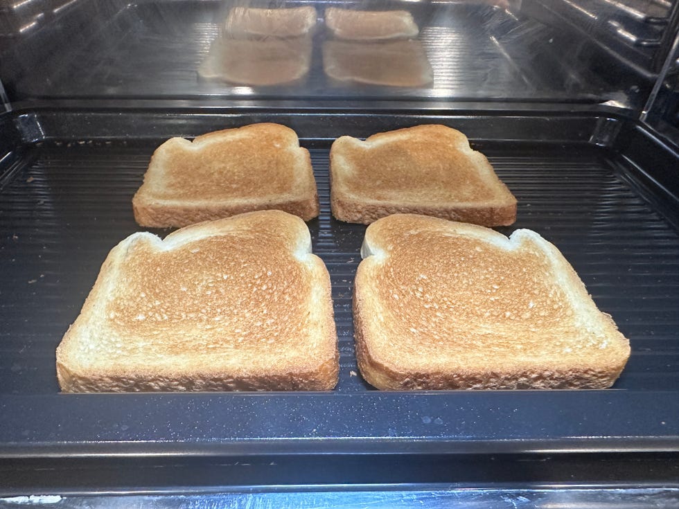 four slices of bread evenly toasted on toast pan