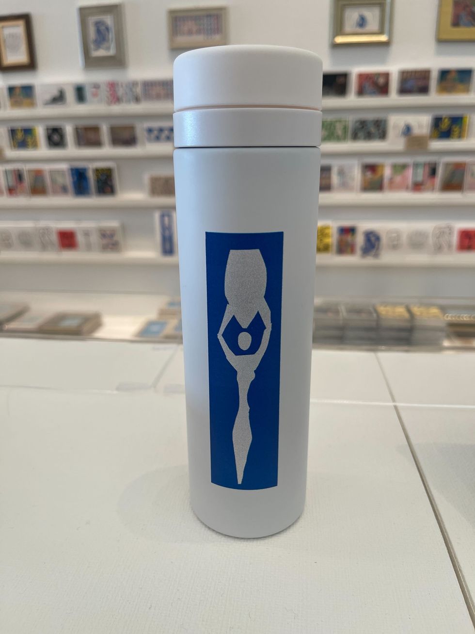 a white cylinder with blue text on it