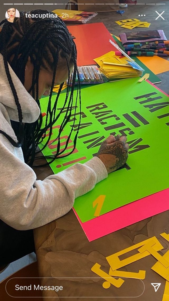 rihanna adds letters to a green poster board