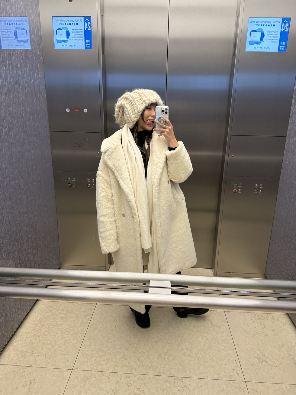 individual wearing a white coat and hat in an elevator