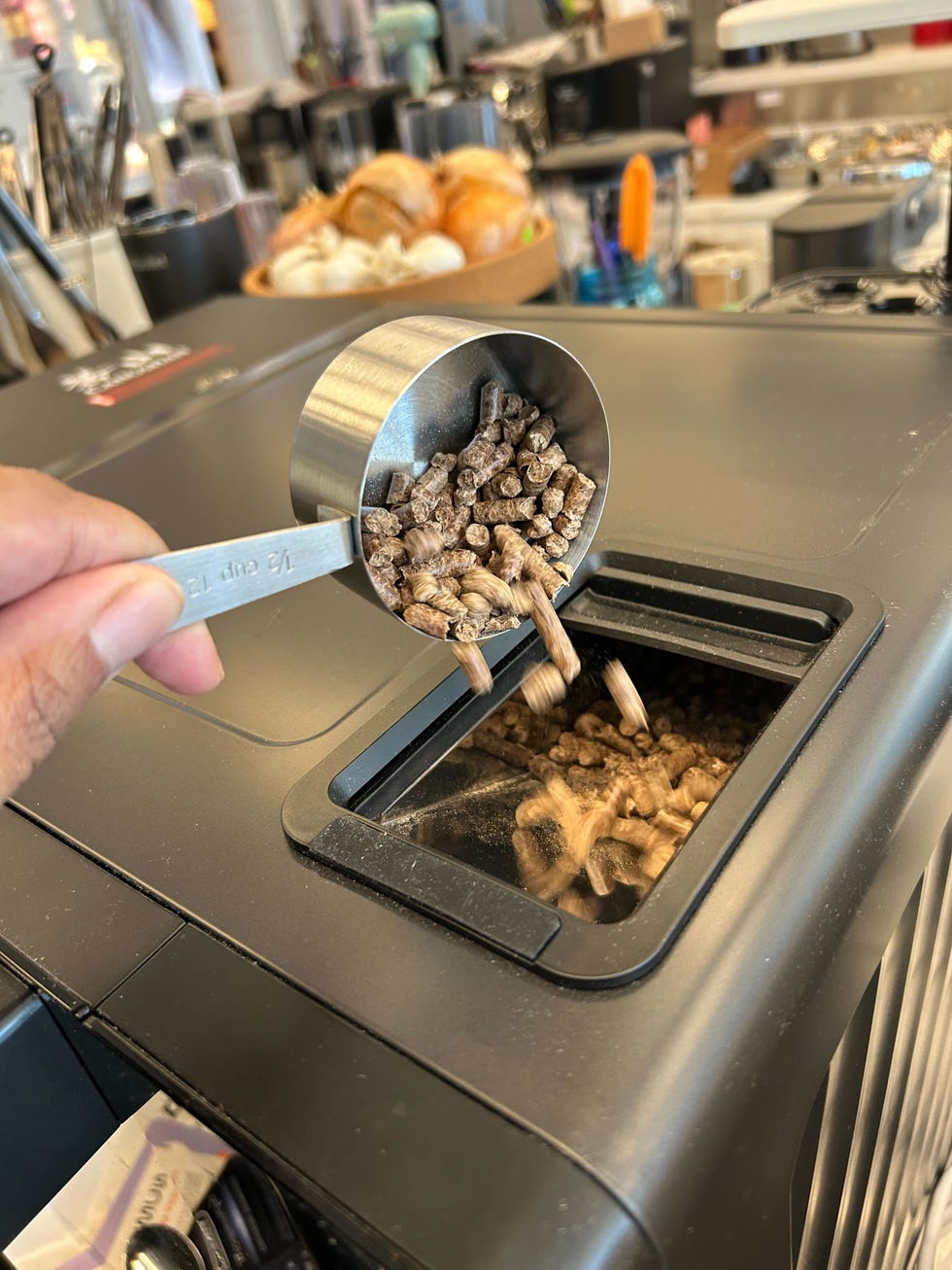 measuring out ingredients with a cup over a container