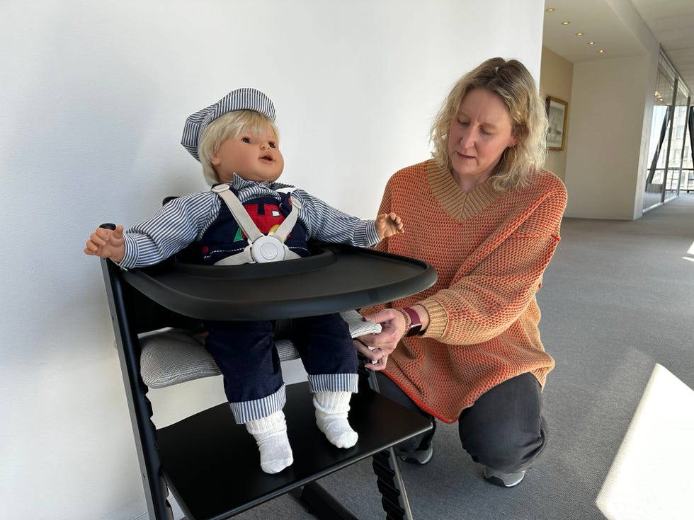 a member of the good housekeeping institute tests a tripp trapp high chair with a doll