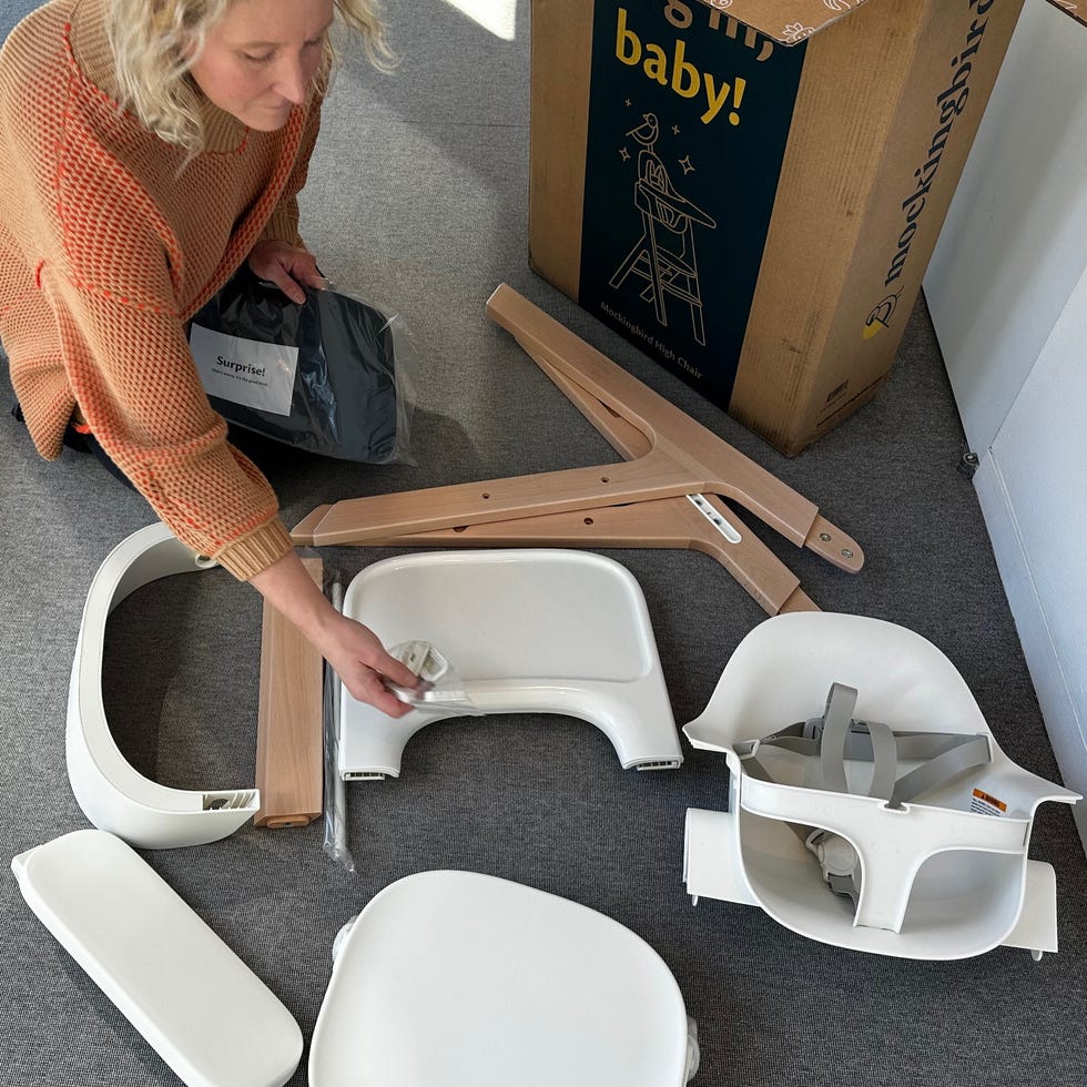 assembling a high chair at the Good Housekeeping Institute a member of the good housekeeping institute assembles and tests a high chair