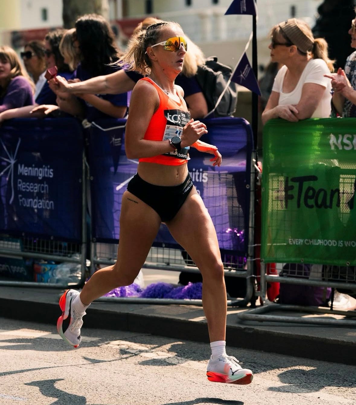 a female runner in athletic attire participating in a race