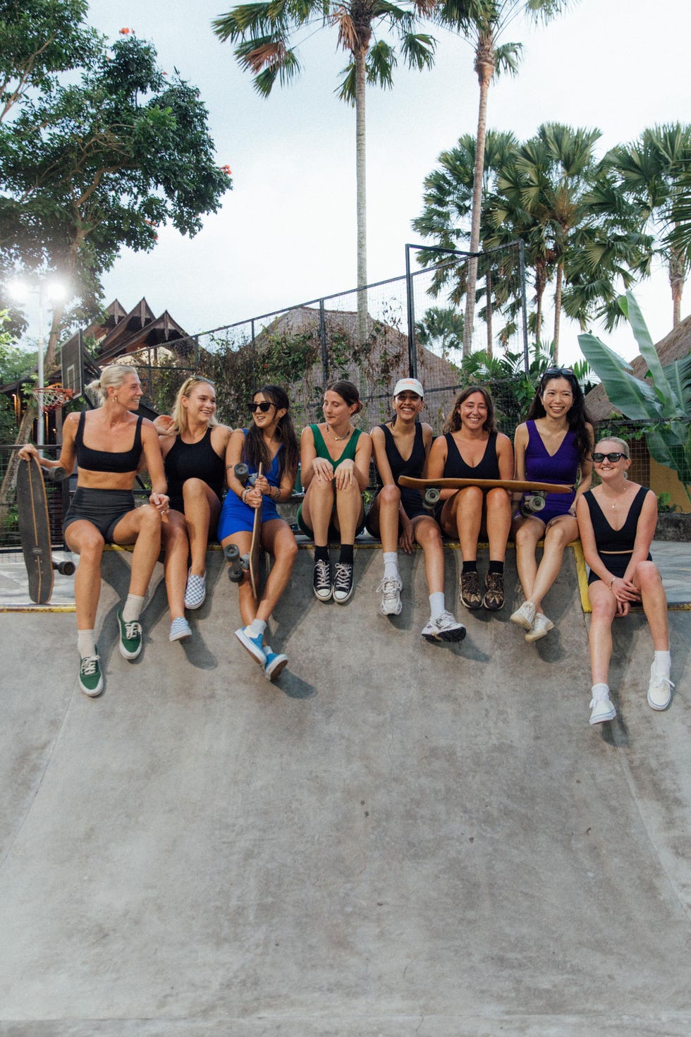 group of skateboarders sitting on a ramp in a skatepark