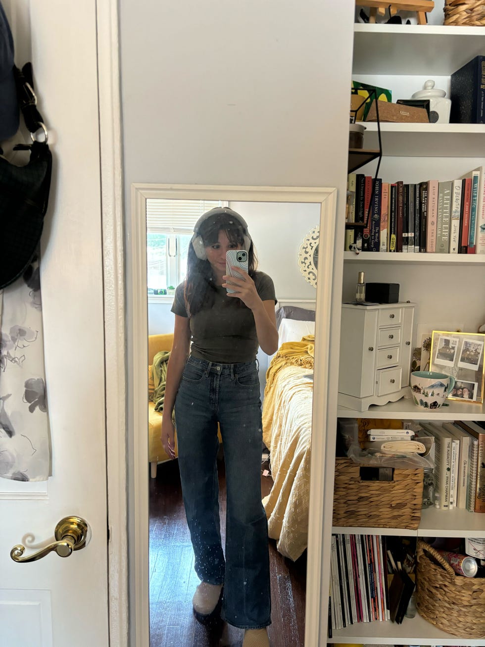 a teste wearing gap jeans in a mirror selfie with over the ear headphones, good housekeeping's best jeans for women