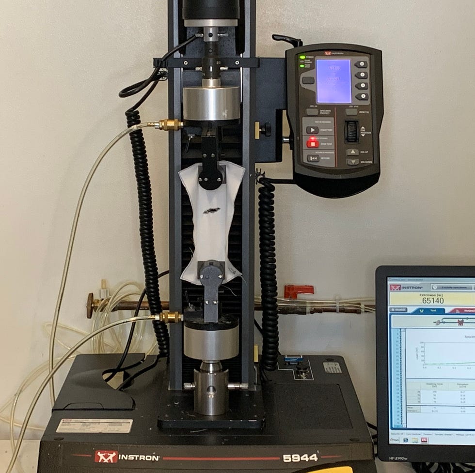 an instron machine testing fabric strength of a sheet swatch at the good housekeeping institute, part of good housekeeping's best sheets test