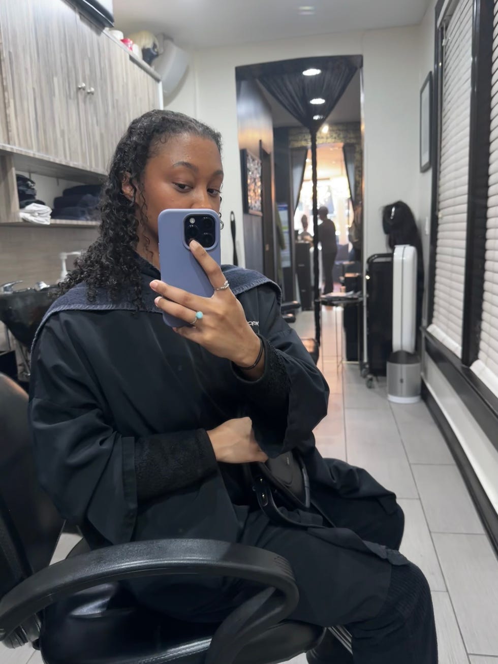 salon setting with client sitting at wash bowl