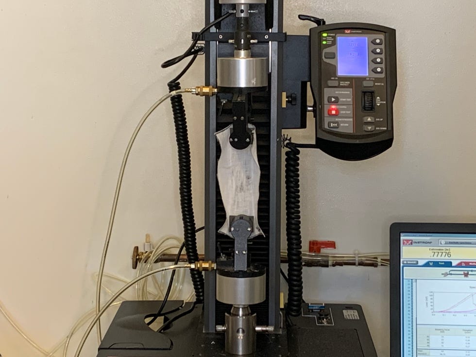 an instron machine testing sheet fabric strength in the good housekeeping institute textiles lab