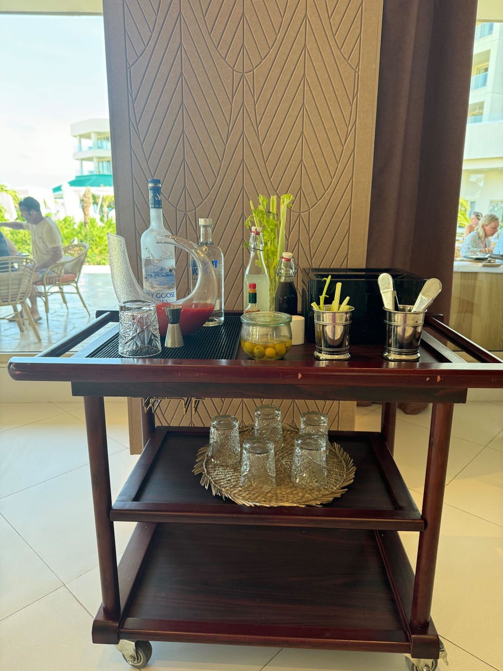 a cocktail cart with various drinks and mixers