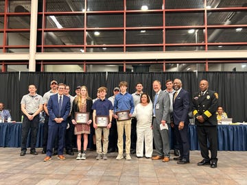 group of students standing with award