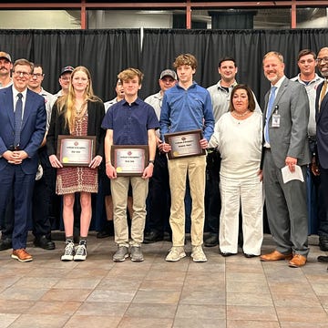group of students standing with award group of students standing with award