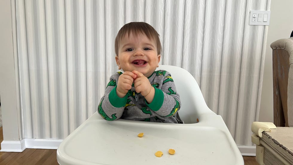 child seated in a high chair testing yumi smoothie melts