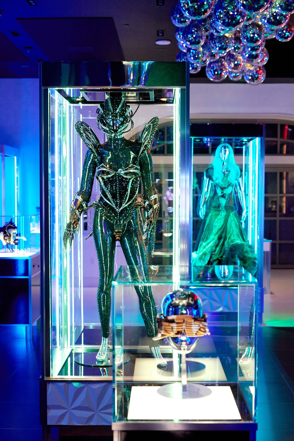 Blue, Display case, Design, Glass, Technology, Architecture, Electric blue, Display window, Fictional character, Plant, 