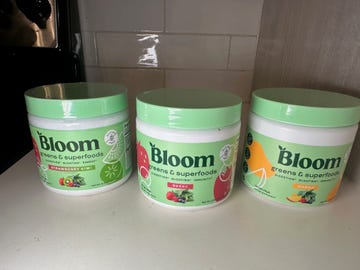 three containers of bloom greens and superfoods in various flavors