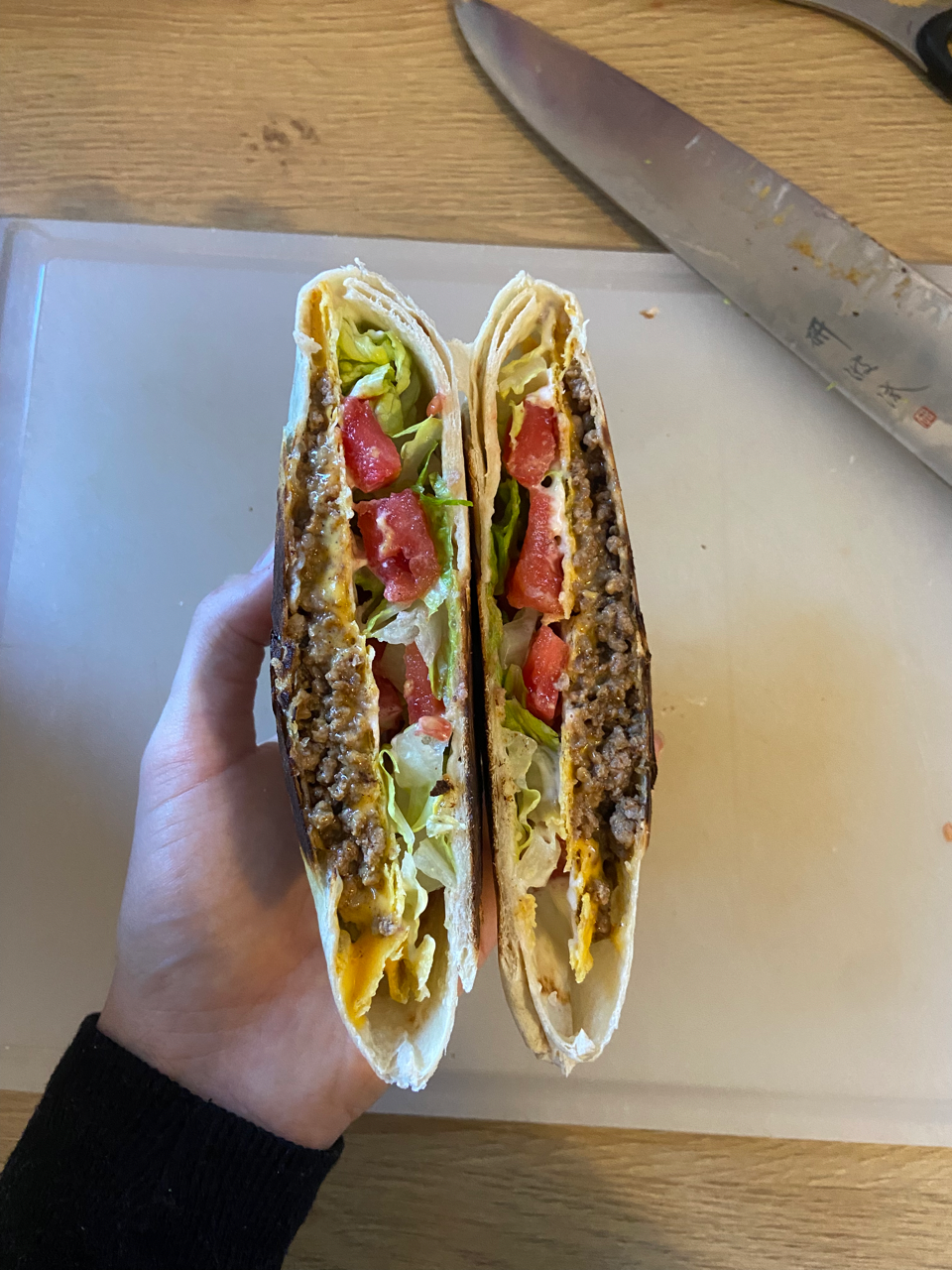 a person holding a sandwich