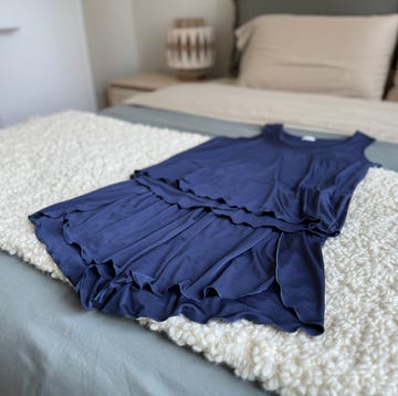 navy blue clothing set on a bed navy blue clothing set on a bed