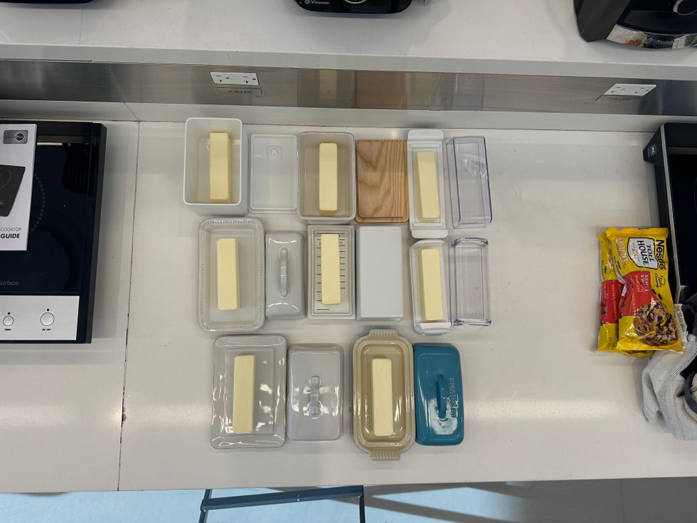 variety of butter containers arranged on a countertop alongside cookie dough