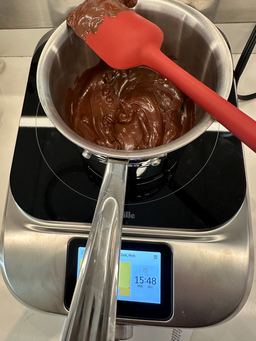 pot with chocolate melting inside on portable induction cooktop