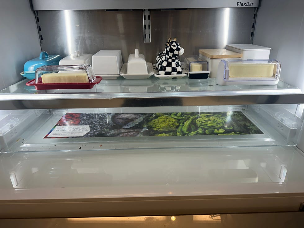 refrigerator shelf containing various butter dishes and containers