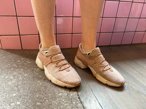 a model wearing pink avre slip on sneakers on a pink set, part of good housekeeping's testing for best walking shoes for women
