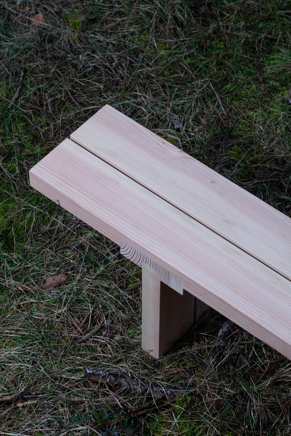 a wooden bench on grass