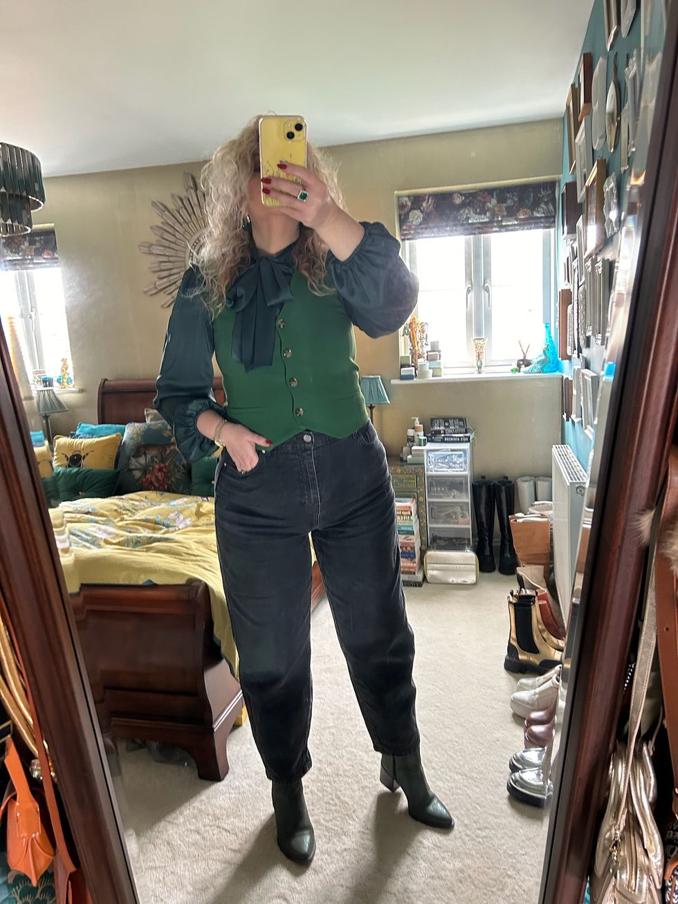 green waistcoat with jeans and a big blouse