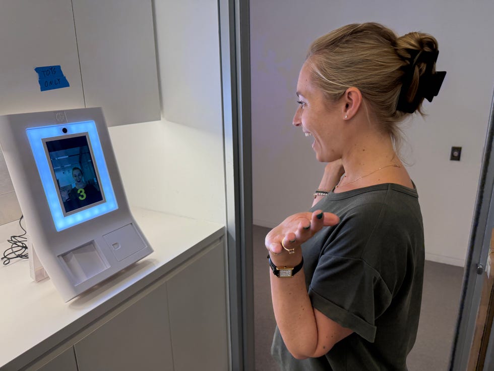 interactive kiosk with a display and a user interacting with it